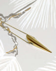 Pike Pendant photographed in soft lighting – A designer gold pendant blending minimalism with bold elegance.