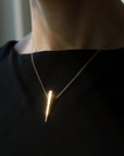Pike Pendant in Yellow Gold worn as a statement piece – A sleek, edgy pendant that enhances any outfit with its bold shape.