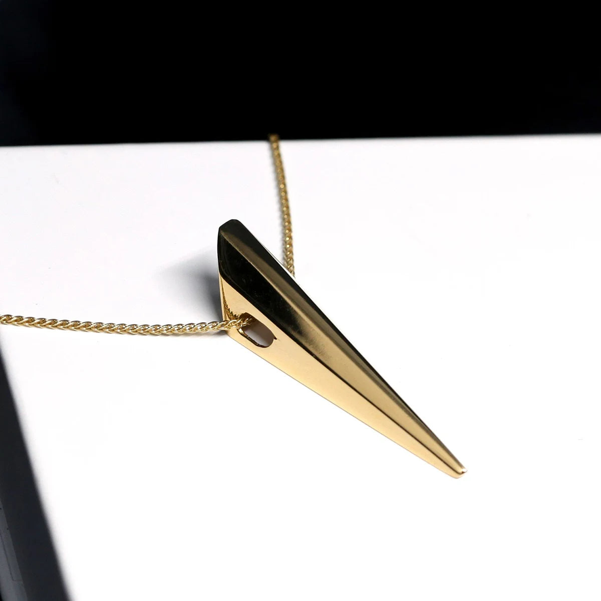 Close-up of the polished surface of the Pike Pendant in Yellow Gold – A high-shine statement jewelry piece with a modern, sculptural design.