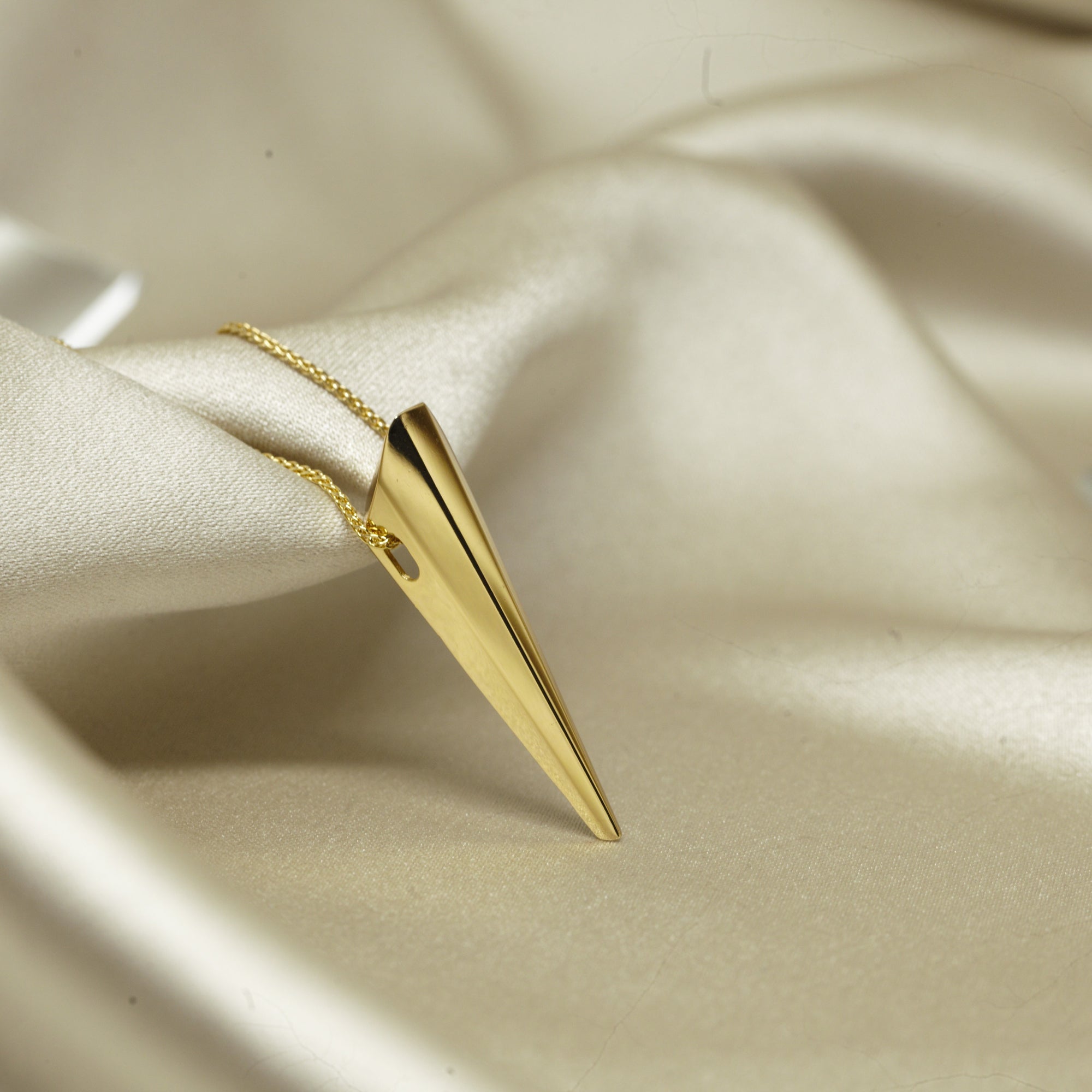 Close-up of Pike Pendant on a jewelry tray – A modern pendant with sharp lines, reflecting light beautifully.