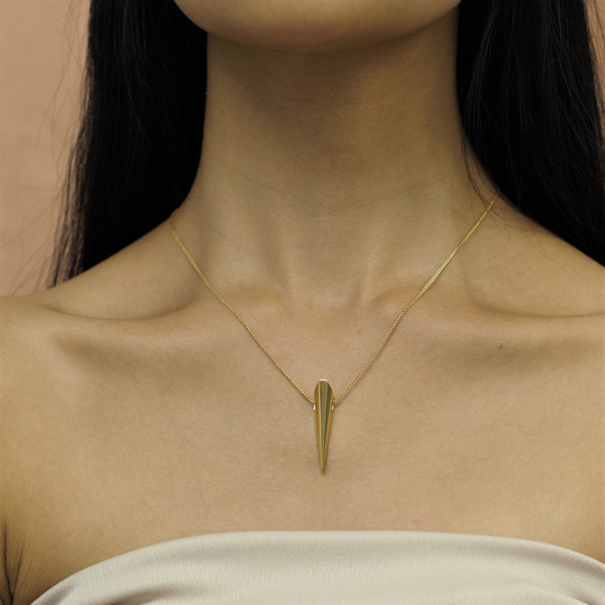 Yellow Gold Pike Pendant layered with other fine jewelry – A striking, modern pendant perfect for layering or wearing solo.
