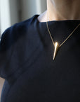 Side view of Pike Pendant on a model’s neckline – A bold yet minimalist piece, designed for everyday elegance.