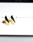 Top-down view of gold earrings – Sleek, edgy earrings with a clean, architectural shape. A signature design from Bena Jewelry, made in Canada.