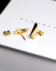 Pike Earrings on soft-toned background – These gold earrings blend elegance and modernity, designed for a bold, unisex look. Handcrafted in fine jewelry tradition.
