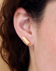 Close-up of Pike Earrings – Bold and minimalist gold earrings with sharp, refined lines, designed for a contemporary aesthetic.