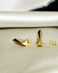 Angled shot of Pike Earrings on white background – Unisex gold earrings with a sleek, minimalist design. A refined statement piece crafted by Bena Jewelry in Montreal.