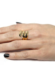 Angled shot of Embrace Ring in Yellow Gold – A sleek, stacked gold ring with a distinctive, layered silhouette.