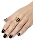 Embrace Ring in Yellow Gold worn on hand, close-up – A bold and modern unisex gold ring, designed for statement wear.