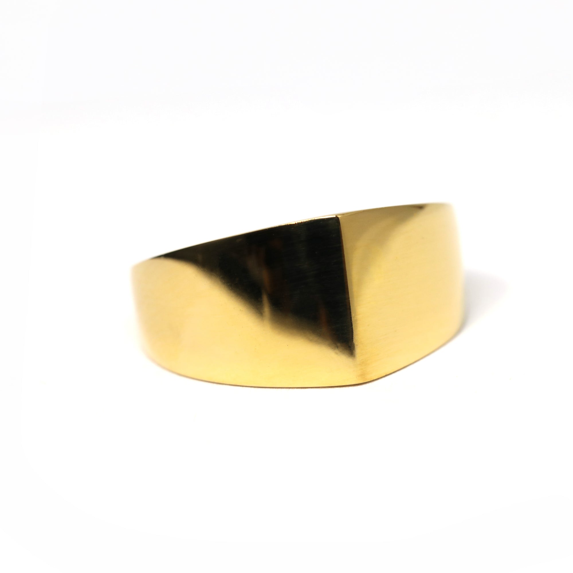 Close-up of Lump Ring in Yellow Gold – A sleek, asymmetrical gold ring with a smooth, high-polish finish.