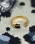 Side view of Frill Ring in Yellow Gold – A modern, sculptural unisex ring featuring a curved and open-ended design.