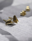 Edges Gold Studs in yellow gold by Bena Jewelry, featuring an edgy minimalist design, photographed on a dark background, modern unisex jewelry crafted in Canada