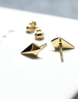Back view of gold studs on dark background – A sleek and contemporary fine jewelry piece, perfect for understated elegance.
