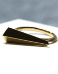 Angled shot of Spine Ring in Yellow Gold – A high-polish statement ring with an architectural edge.
