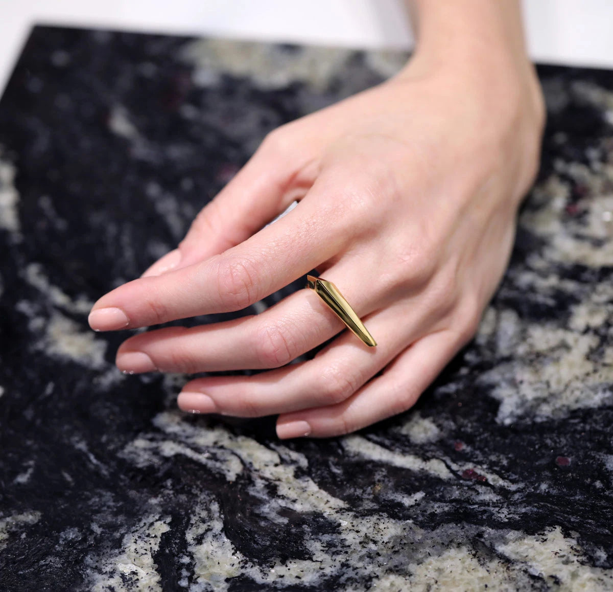 Allure unisex statement ring in yellow gold by Bena Jewelry, worn by a lady and photographed in close-up. Our ready-to-wear fashion jewelry available online.