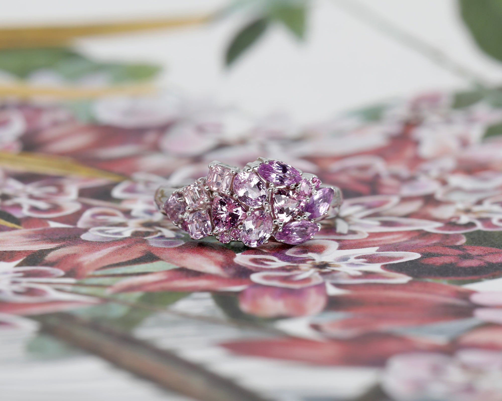 Front view: The Avalanche Berry Mousse Ring against a colored background, emphasizing the soft lilac tones of the sapphires and the warm yellow gold. Made in Montreal, Canada, by Bena Jewelry.