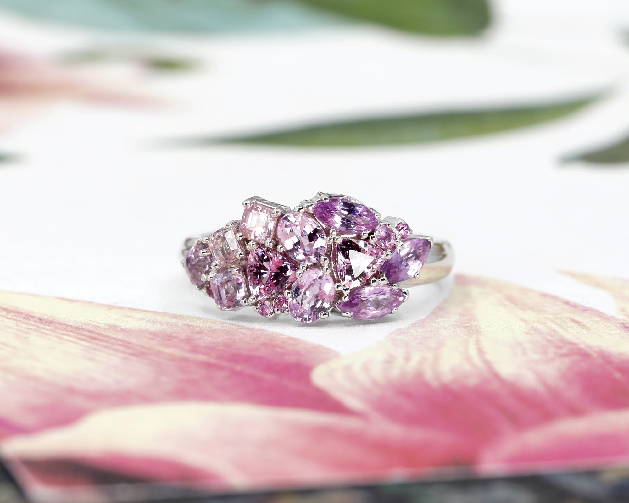 Angled side view: Highlights the intricate gemstone arrangement and the polished yellow gold, designed by Bena Jewelry in Montreal, Canada.