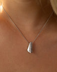 Close-up of the Balast pendant in 14k white gold, featuring a sleek geometric silhouette and pavé-set diamonds. A modern statement necklace handcrafted by Bena Jewelry in Montreal.
