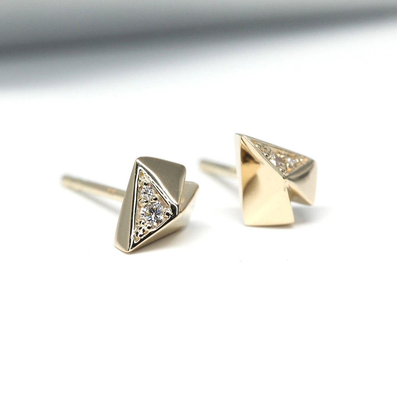 Side view of a pair of diamond yellow studs in a funky heart shape. These gold studs are custom made in montreal by independent designer Bena jewelry and are availabe at the best jewelery store in canada: Boutique Ruby Mardi.