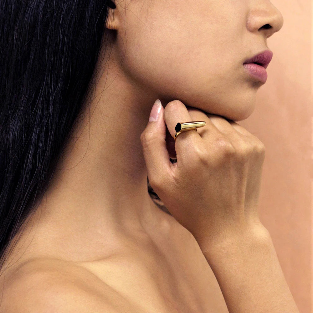 Fashion shot of STURDY RING by Bena Jewelry: a yellow gold statement unisex ring. The bold ring is worn by an asiatic lady. 