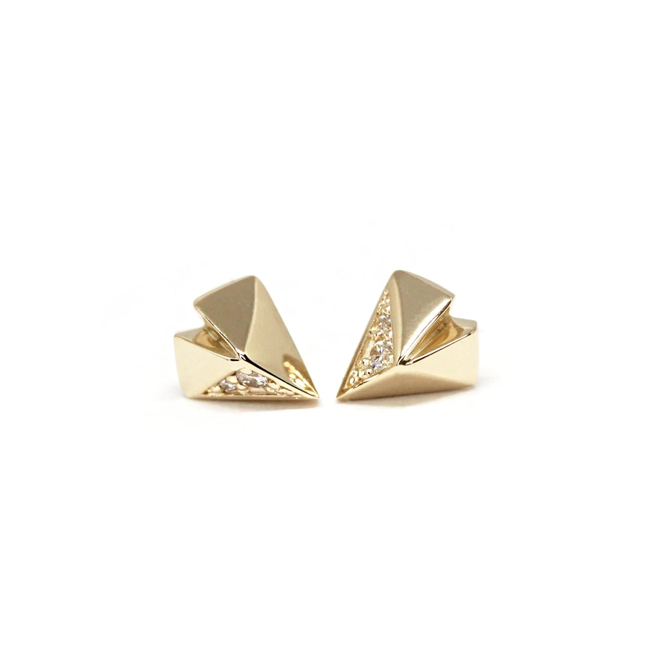 Diamond stud earrings with an edgy style photographed on a white background. The earrings have a funky heart shape and are casted in yellow gold. They have 4 small natural diamonds. This jewel was designed in Montreal by Bena Jewelry. 