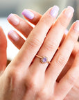 Hand wearing a Bena Jewelry sapphire ring with a lavender opalescent sapphire and champagne diamond halo in rose gold. Independent Canadian designer jewelry from Montreal.