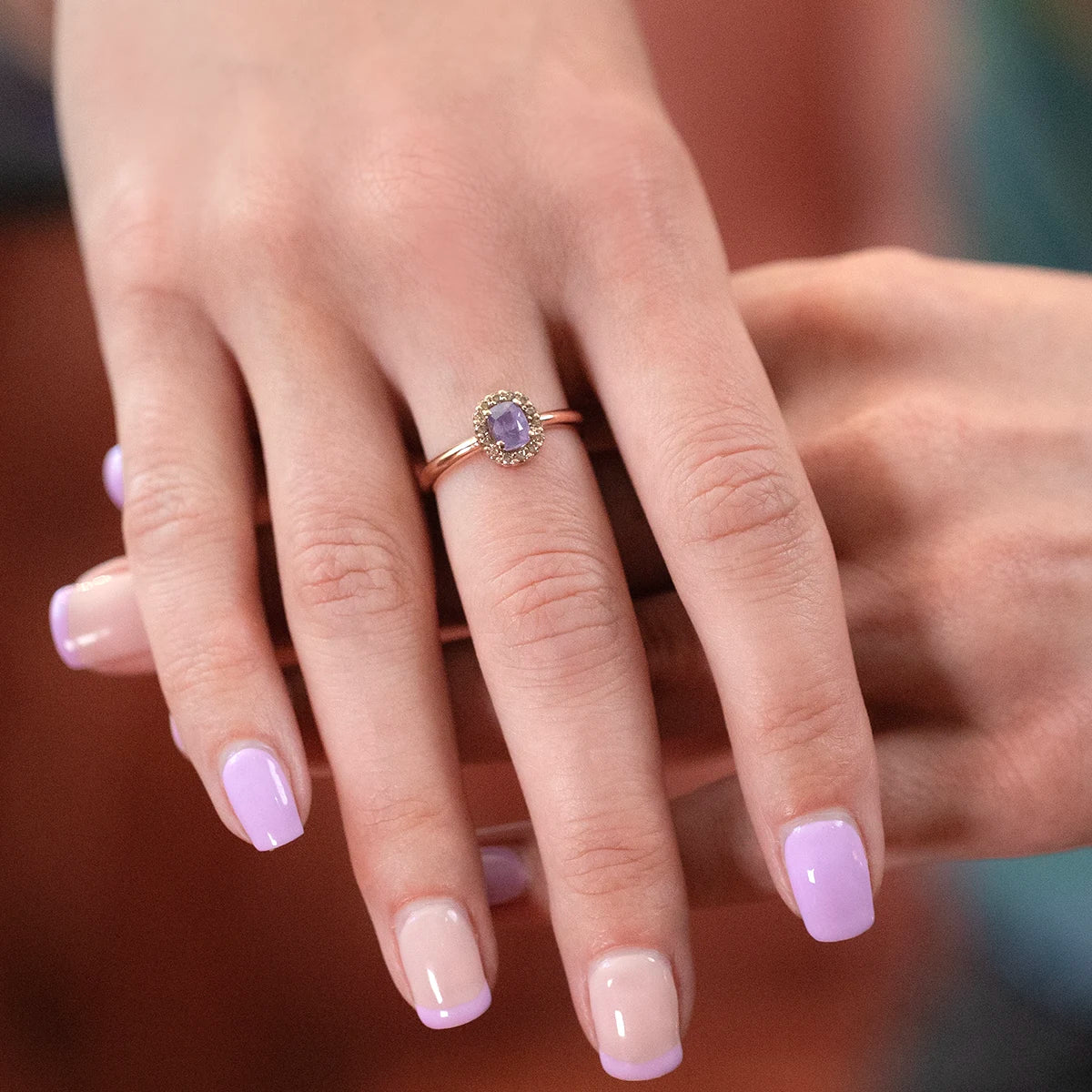 Bena Jewelry rose gold ring featuring an opalescent purple sapphire surrounded by natural champagne diamonds. Contemporary fine jewelry designed and made in Montreal, Canada.