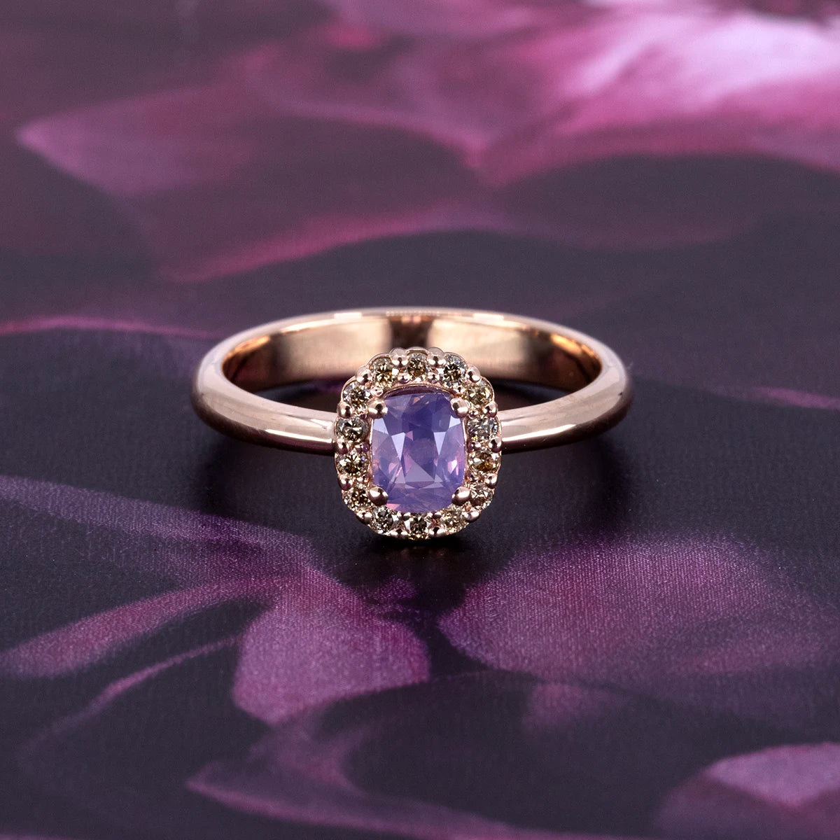 Bena Jewelry purple sapphire halo ring in rose gold with natural champagne diamonds. Contemporary engagement ring alternative designed and made in Montreal.