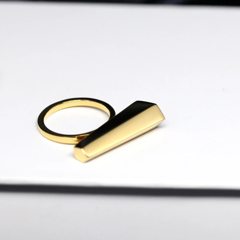 Sturdy designer ring in yellow gold photographed on a white background. A Minimalist, modern and elegant piece of jewelry. Find this gender-neutral ring that fits both classic and edgy wardrobes online or at Bena Jewelry&#39;s Montreal store.
