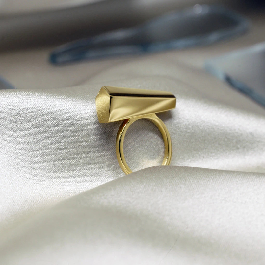 Canadian jewelry designer Bena Jewelry&#39;s yellow gold Sturdy ring, photographed in close-up on a satin fabric. Modern and predominantly handcrafted jewelry available online or at our jewellery store in Montreal&#39;s Little Italy.