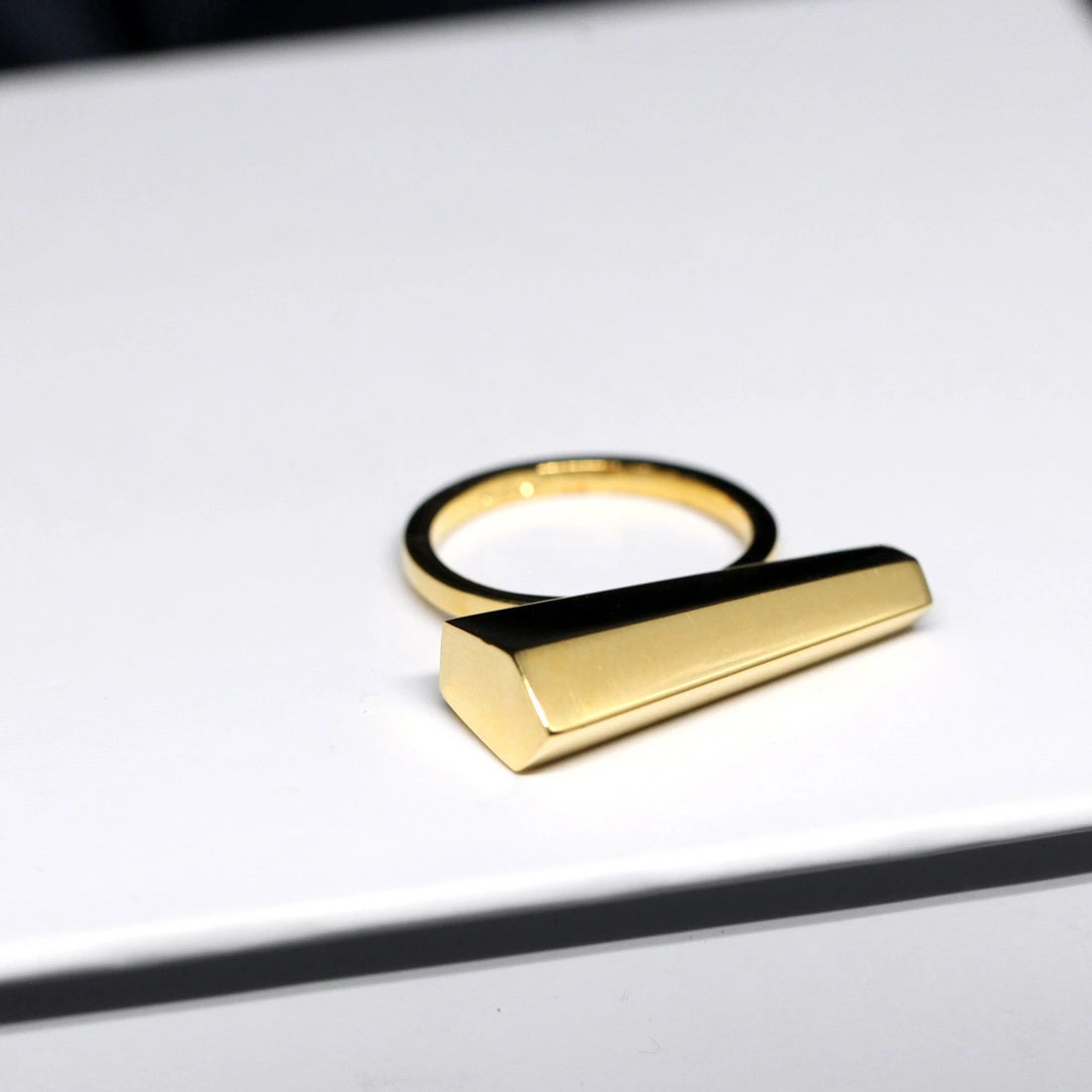 Sturdy ring in yellow gold  photographed on a white background. A Minimalist, modern and elegant piece of jewelry. Find this gender-neutral ring that fits both classic and edgy wardrobes online or at our Montreal jewelry store.