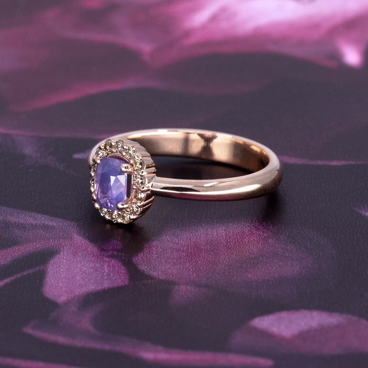 Rose gold halo ring by Bena Jewelry featuring an opalescent lavender sapphire and champagne diamonds. Modern Canadian fine jewelry handcrafted in Montreal.