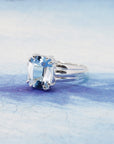 side view of cocktail silver ring with big aquamarine gemstone made by the designer bena jewelry in montreal and best candian jeweller on blue background