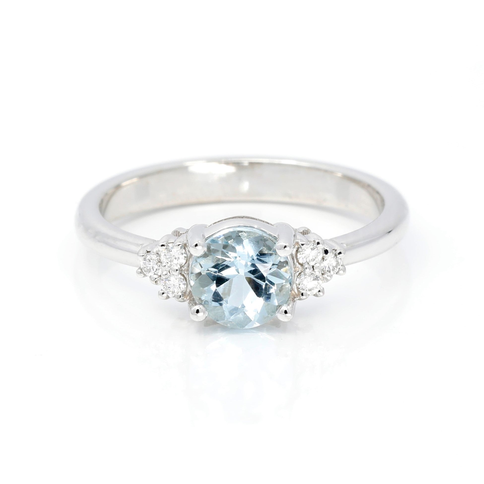 Top view: Showcasing the sky-blue aquamarine centerpiece and the brilliance of the side diamonds set in white gold. Designed by Bena Jewelry, crafted in Montreal, Canada.
