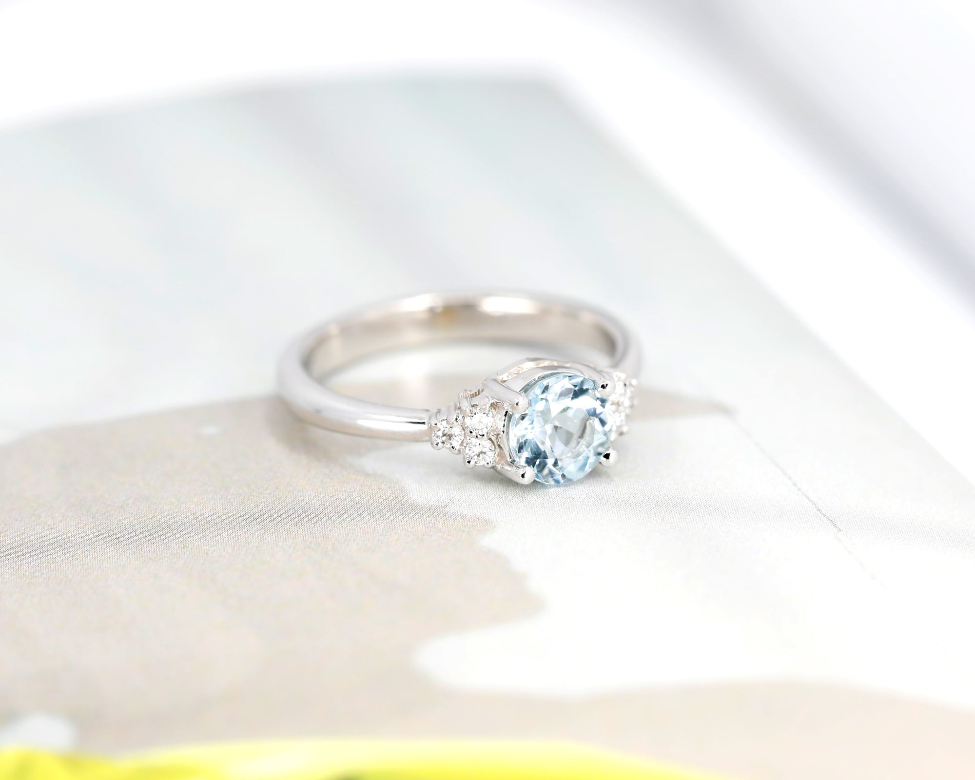 Side angle: Highlights the aquamarine&#39;s delicate blue hue and the sleek white gold setting. A bespoke creation by Bena Jewelry in Montreal, Canada.