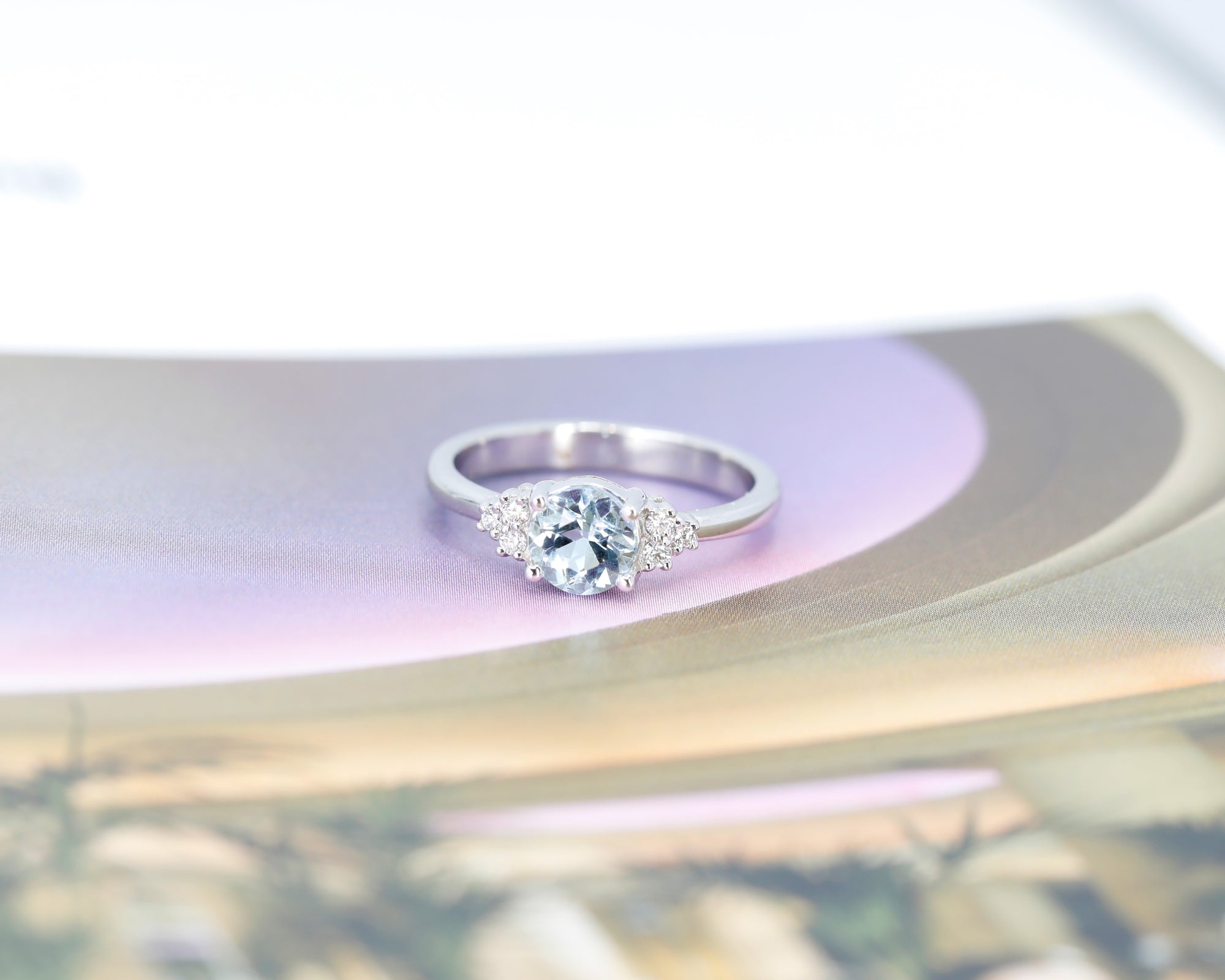 Side angle: Highlights the aquamarine&#39;s delicate blue hue and the sleek white gold setting. A bespoke creation by Bena Jewelry in Montreal, Canada.