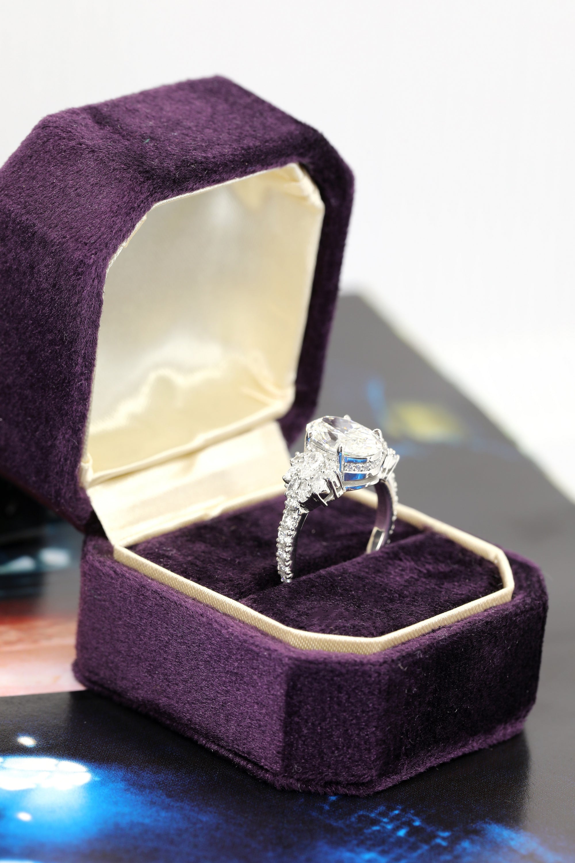 designer engagement ring made in montreal custom made with natural and lab grown diamonds in purple engagement ring jewelry box custom made in montreal by bena jewelry on white background