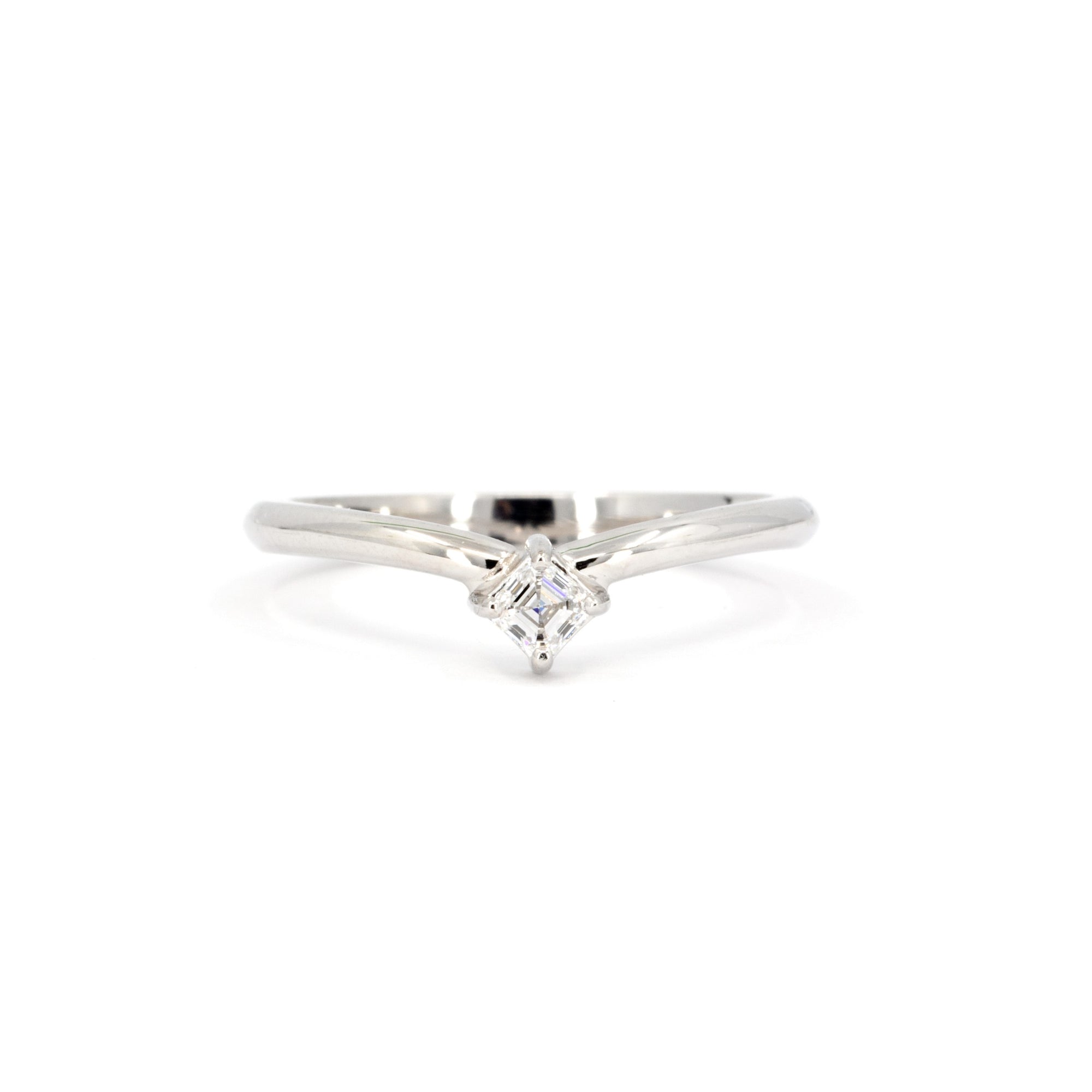 White gold ring with Asscher-cut diamond, featuring a sleek, sculptural design with a slight curve by Bena Jewelry. Perfect for a modern, elegant look.