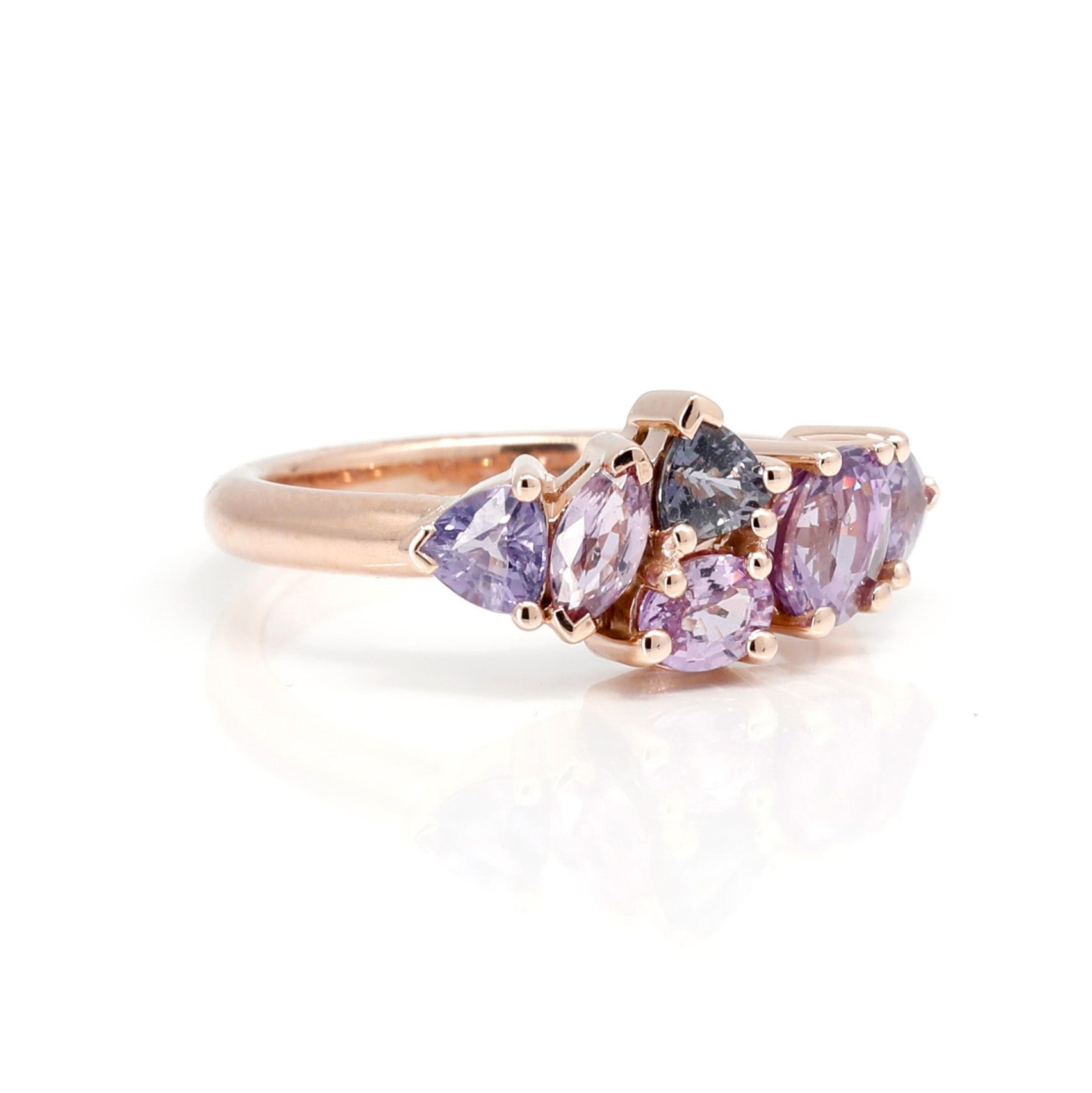 Close-up of the &quot;Avalanche&quot; ring in rose gold with lilac and purple sapphires, showcasing the fine craftsmanship and elegant design. Fine jewelry made in Montreal by Bena Jewelry, presented on a minimalist white background.