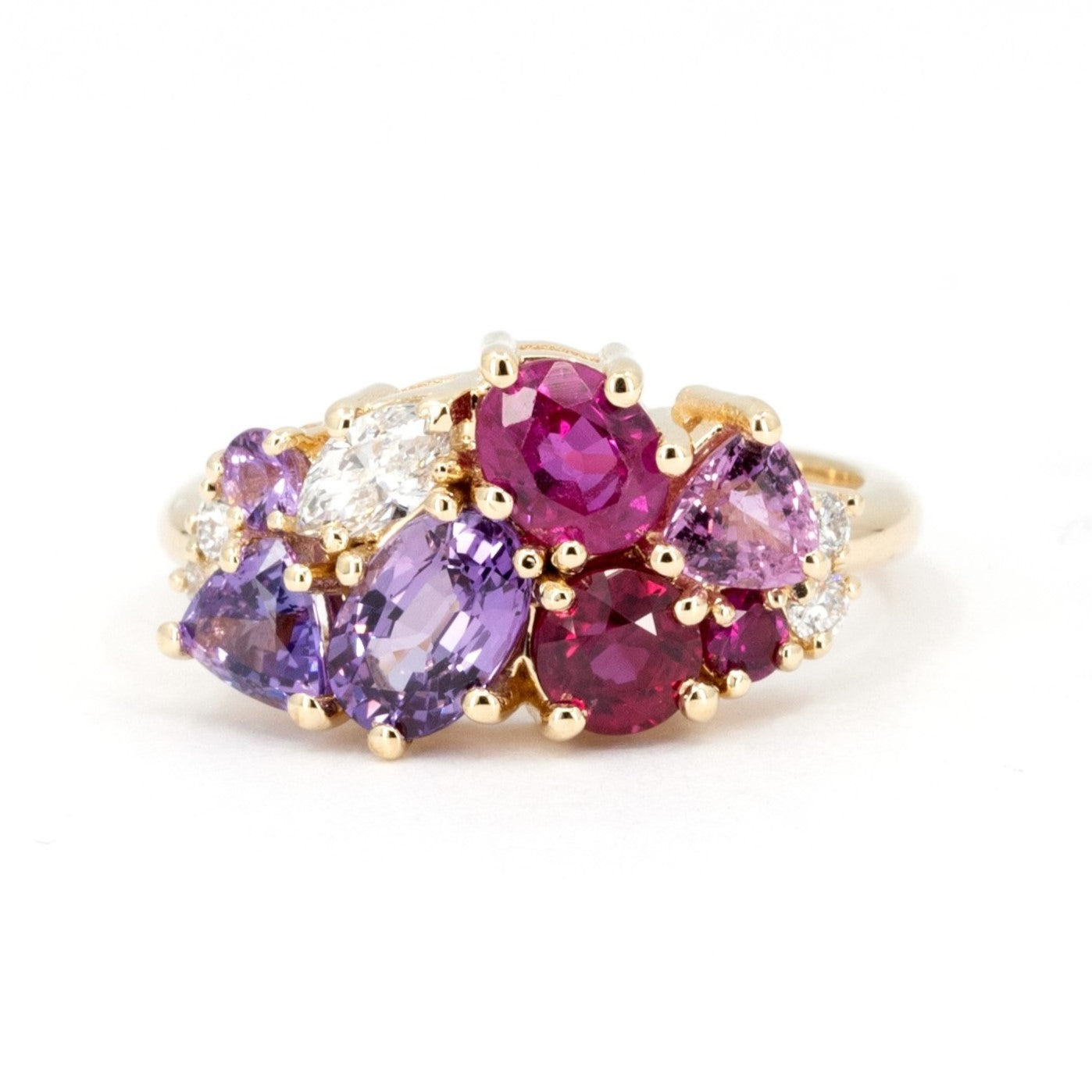 The Avalanche Purple Sapphire & Rubis Ring, featuring a pear-shaped violet sapphire and pink and red rubies, set in polished yellow gold. Designed by Bena Jewelry in Montreal, Canada.