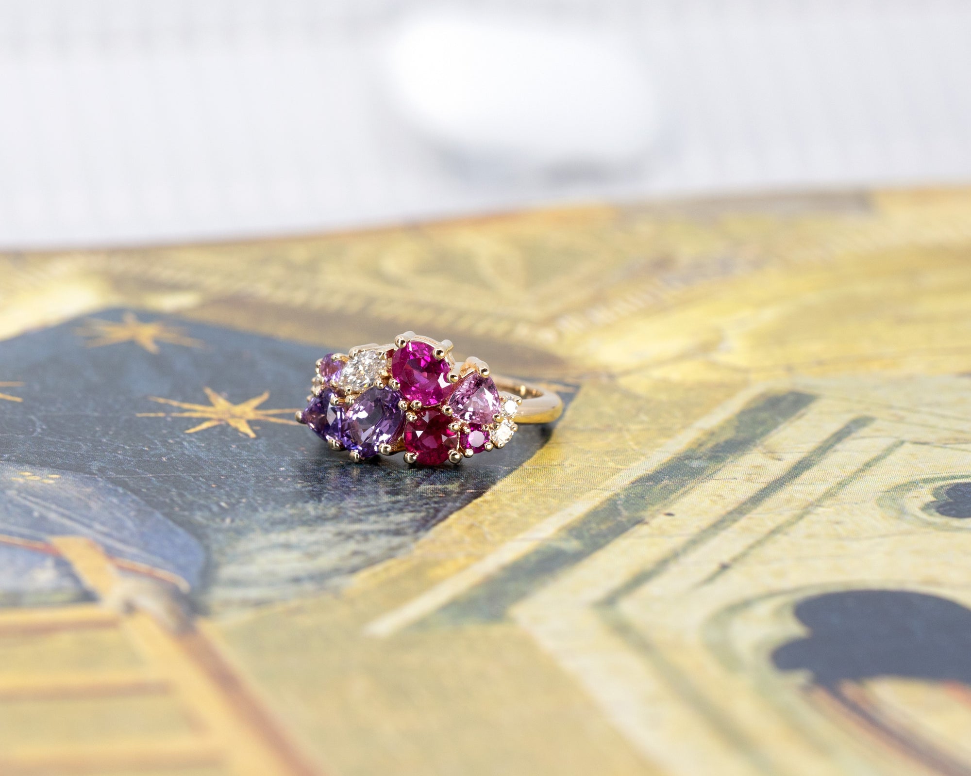 Displays the artistic arrangement of the gemstones and their integration into the gold band. Crafted by Bena Jewelry, Montreal, Canada.
