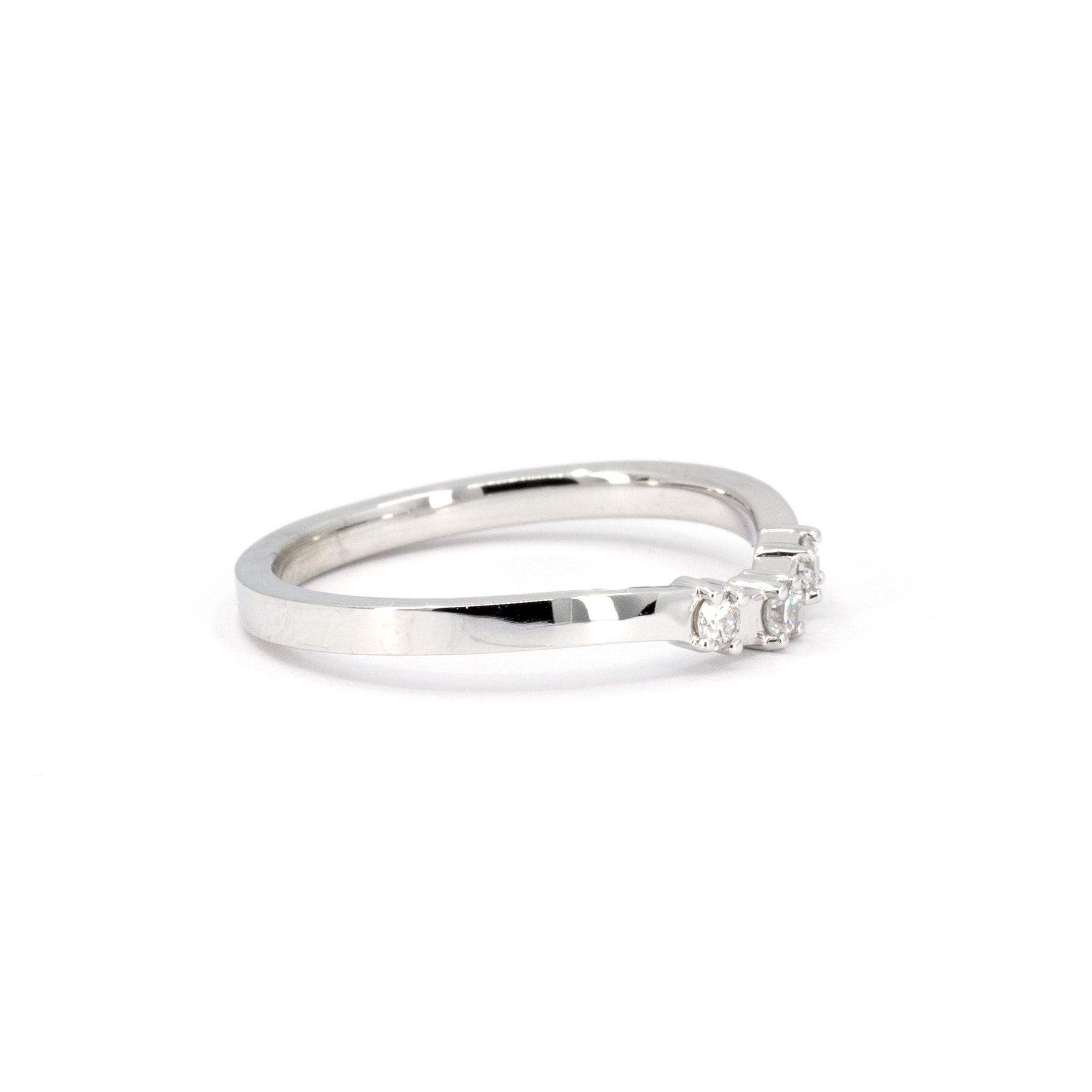 Close-up of the curved diamond band by Bena Jewelry, highlighting the three sparkling diamonds set in a refined, elegant curve.