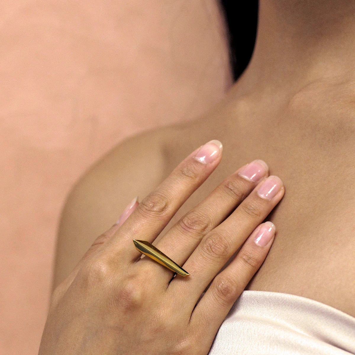 The Allure ring by designer Bena Jewlery here worn by a woman. The jewels in Bena Jewelry&#39;s Edgy collection is gender-neutral, and the shapes are skilfully designed to play with light and shadow. Find our work online or at our jewelry store in Montreal&#39;s Little Italy.