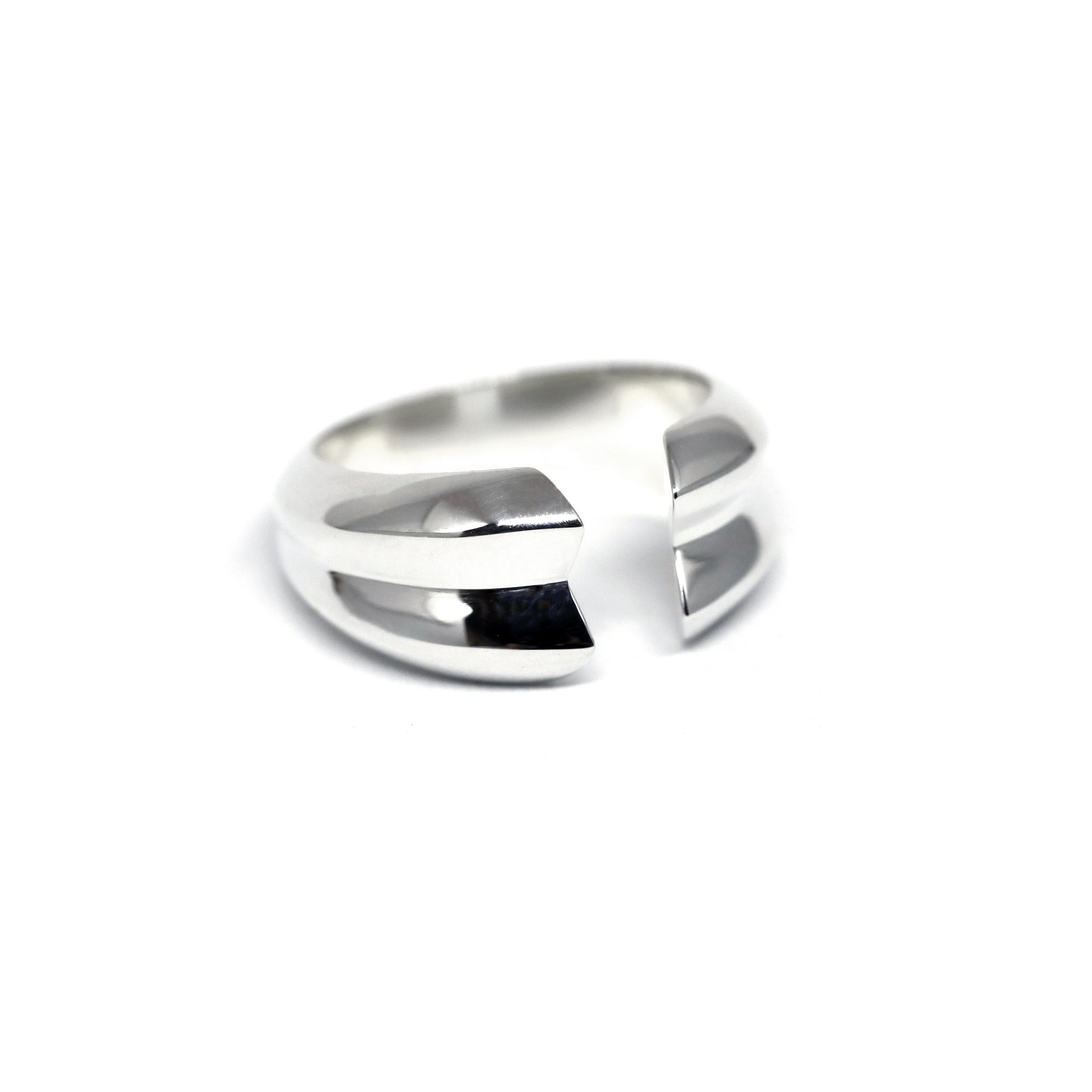 Frill Ring in White Gold on white background – A bold unisex white gold ring with a sleek, open-ended structure. Handmade in Montreal.