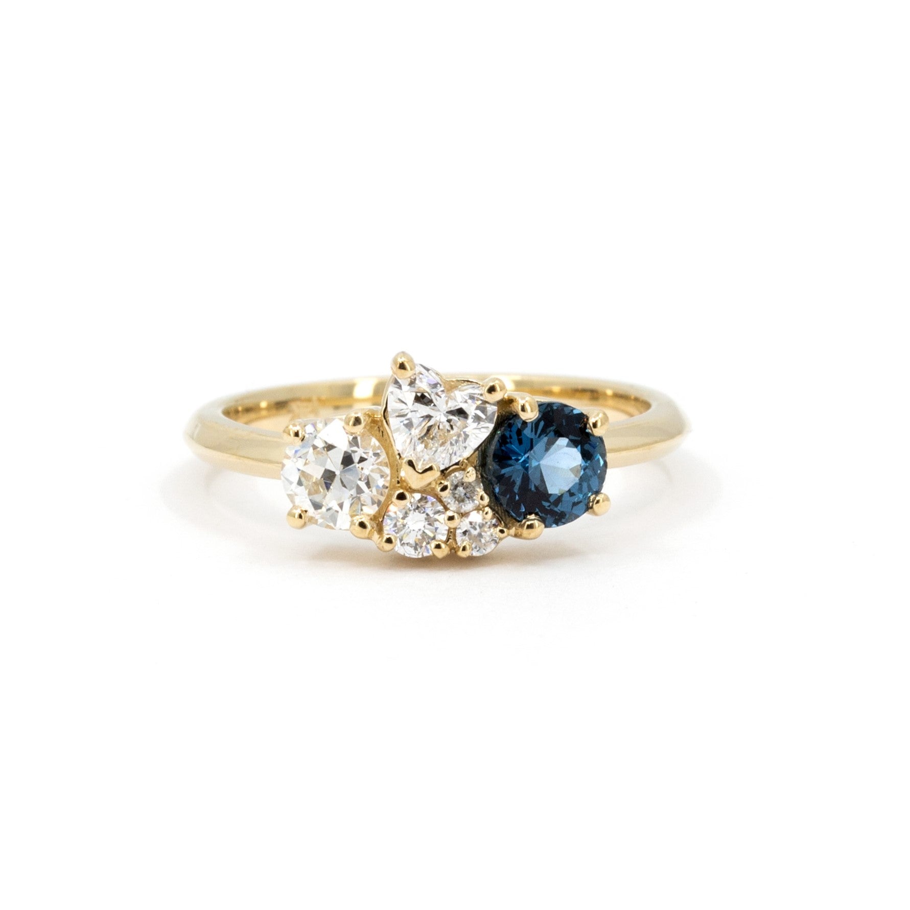 Custom-made yellow gold ring with a blue spinel and diamonds, designed by Bena Jewelry in Montreal.