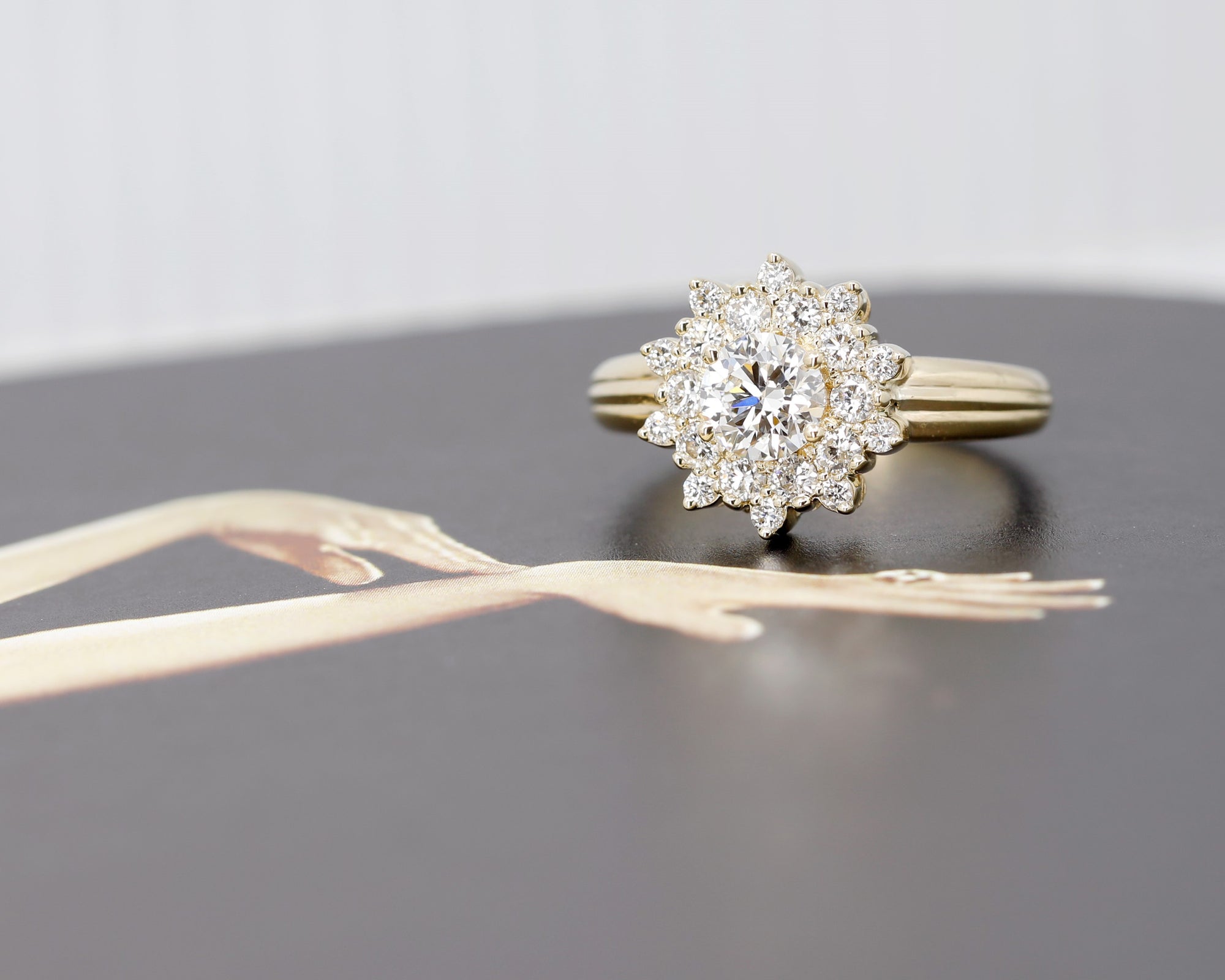 Close-up of the yellow gold diamond halo engagement ring, showcasing its luxurious design and brilliant sparkle.
