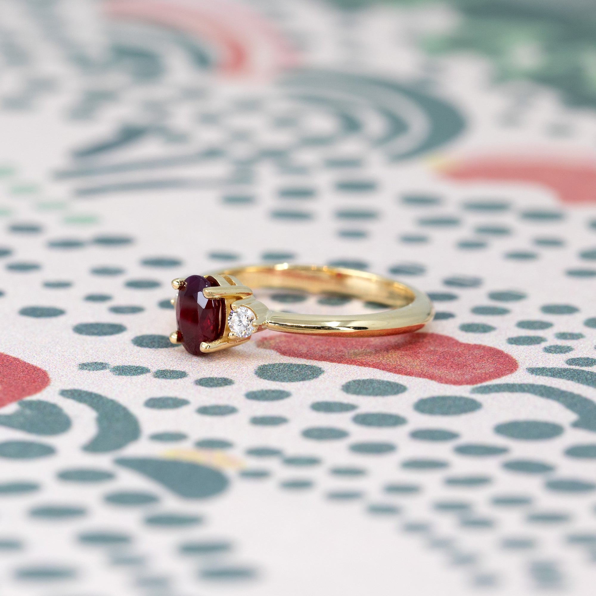 Ruby Flame Ring on soft-toned background – The deep red ruby glows against a warm-toned backdrop, enhancing its regal beauty.