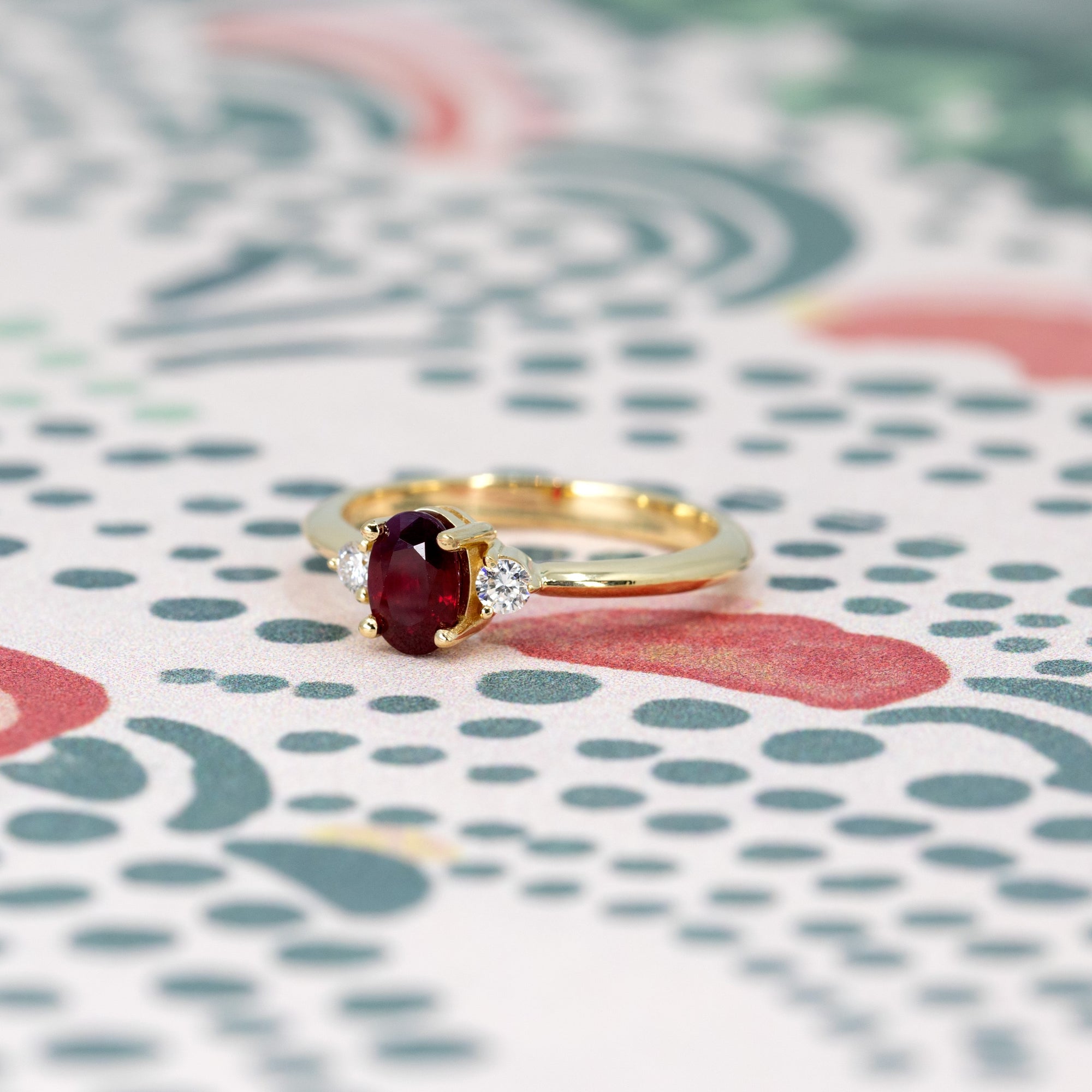 Ruby Flame Ring worn on hand, close-up – A timeless ruby engagement ring set in yellow gold, handcrafted in Montreal by Bena Jewelry.