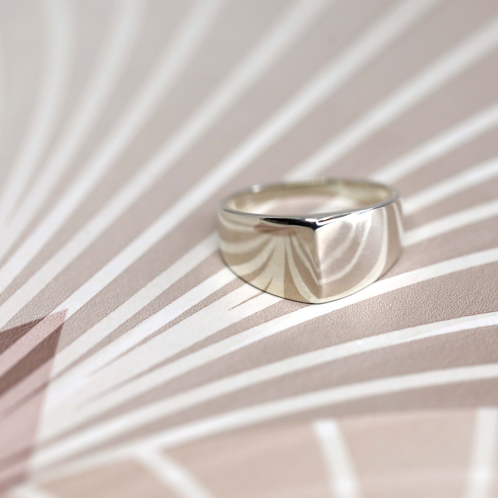 Lump Ring in White Gold on white background – A minimalist unisex ring with an symmetrical design, handcrafted by Bena Jewelry in Montreal.