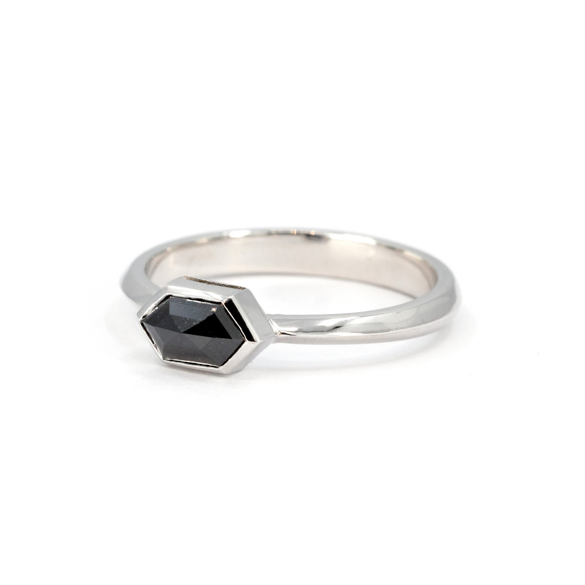 Unique white gold ring with a hexagonal black diamond, custom-designed by Bena Jewelry, highlighting fine craftsmanship and modern design from Canada.