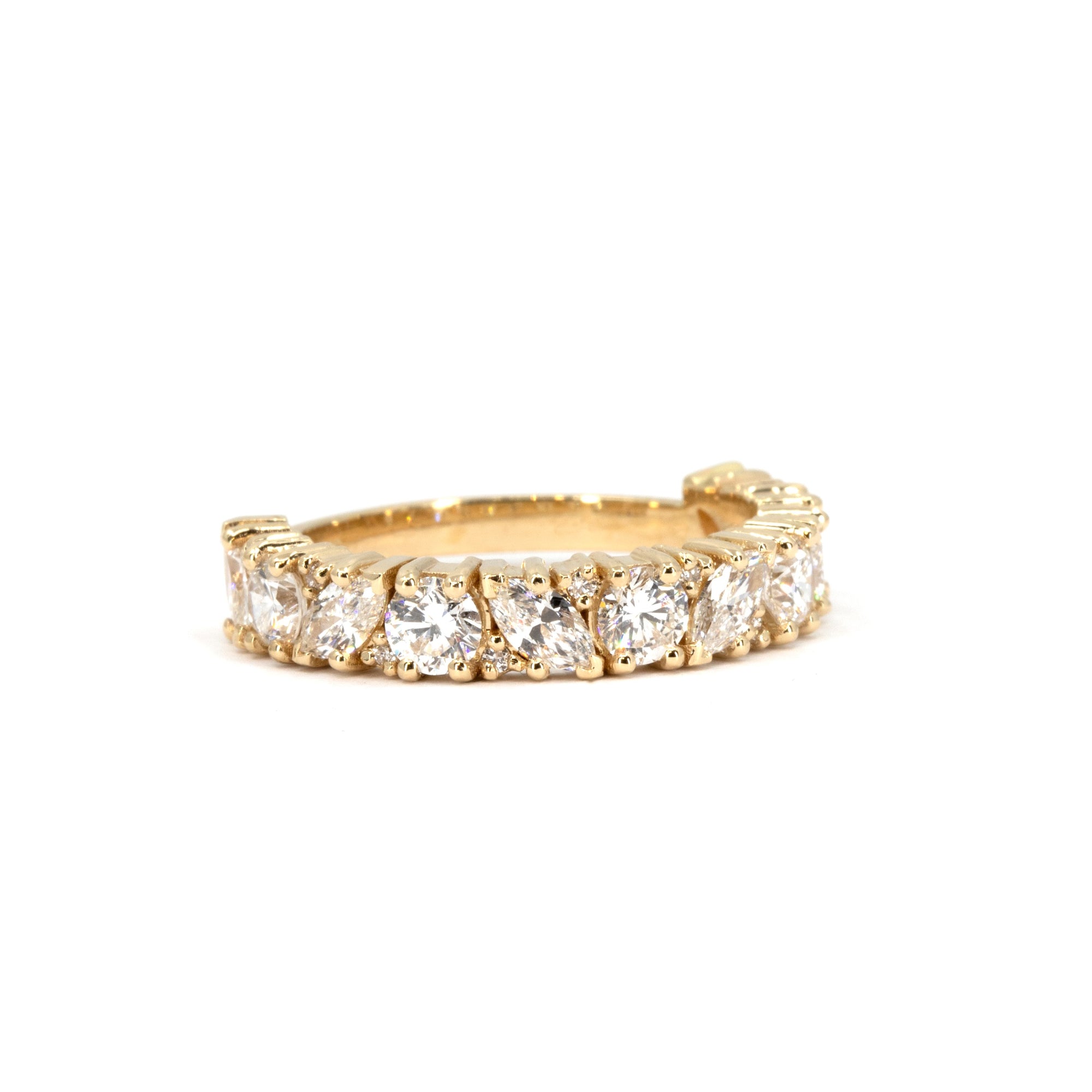 Detailed front angle of a bold 14 kt yellow gold wedding band by Bena Jewelry, crafted in Montreal. Showcasing a stunning mix of marquise and round lab-grown diamonds totaling 1.82 carats.